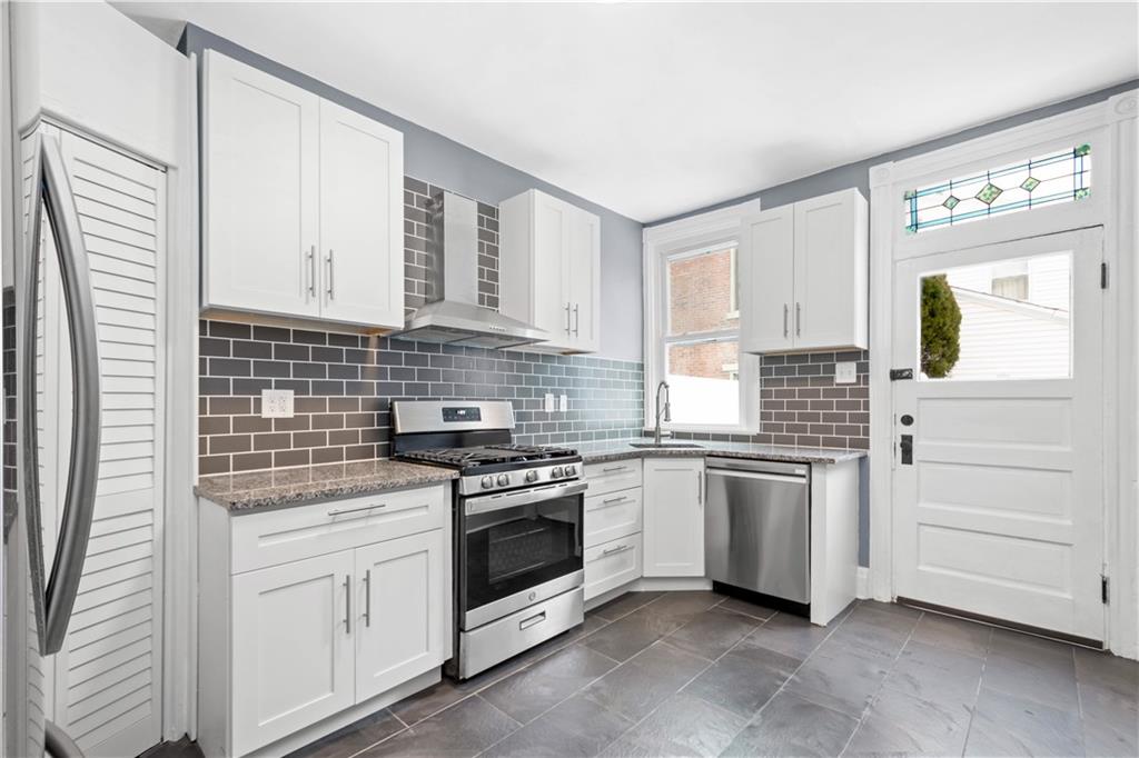 162 Locarna Way Pittsburgh, PA 15201 - Photo 3 of 25 a kitchen with white cabinets and white appliances