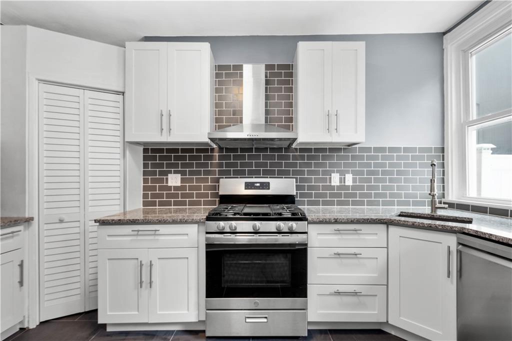 162 Locarna Way Pittsburgh, PA 15201 - Photo 4 of 25 a kitchen with granite countertop white cabinets and appliances