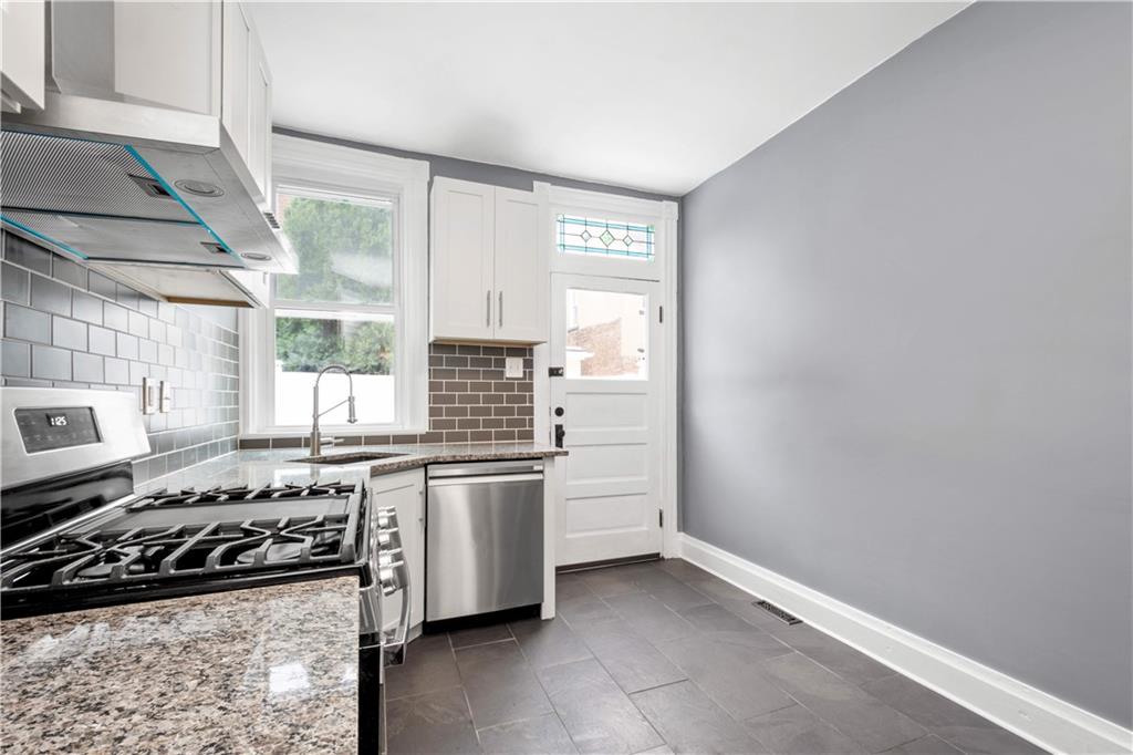 162 Locarna Way Pittsburgh, PA 15201 - Photo 7 of 25 a kitchen with a stove and a refrigerator