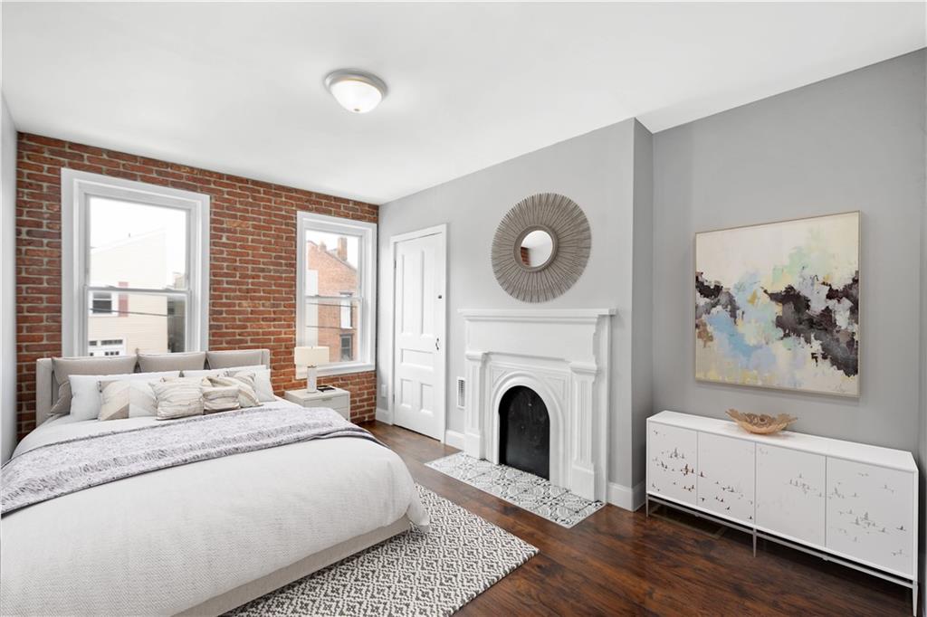 162 Locarna Way Pittsburgh, PA 15201 - Photo 8 of 25 a spacious bedroom with a bed and a fireplace