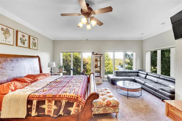 a bedroom with a bed and glass window