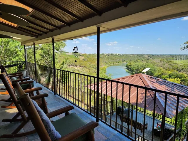 a view of a balcony with floor to ceiling windows with wooden floor