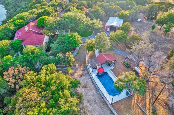 an aerial view of a house with a yard and fountain