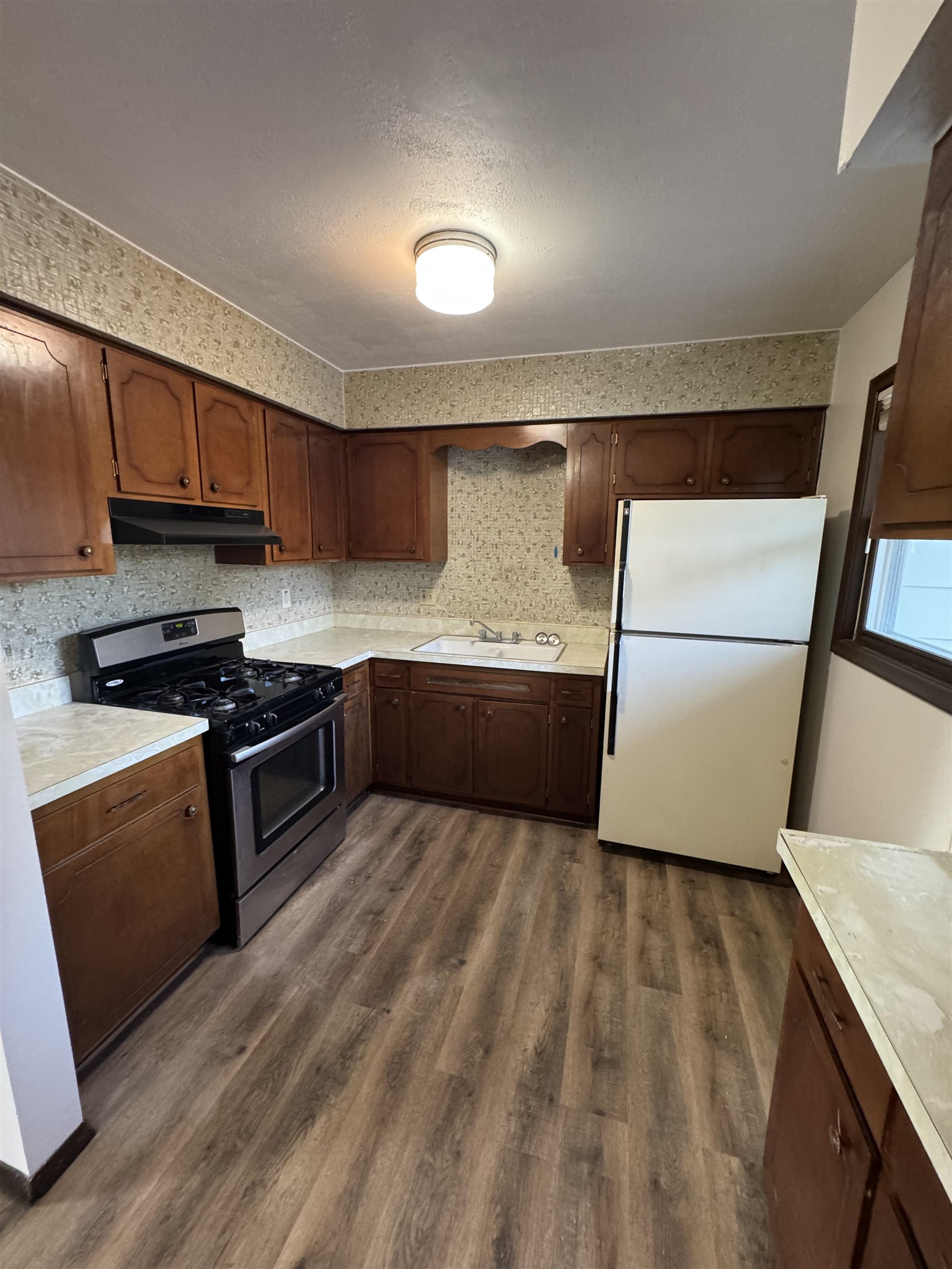 1120 Esmond Drive Rockford, IL 61108 - Photo 11 of 20 a kitchen with stainless steel appliances granite countertop a refrigerator a sink and a stove