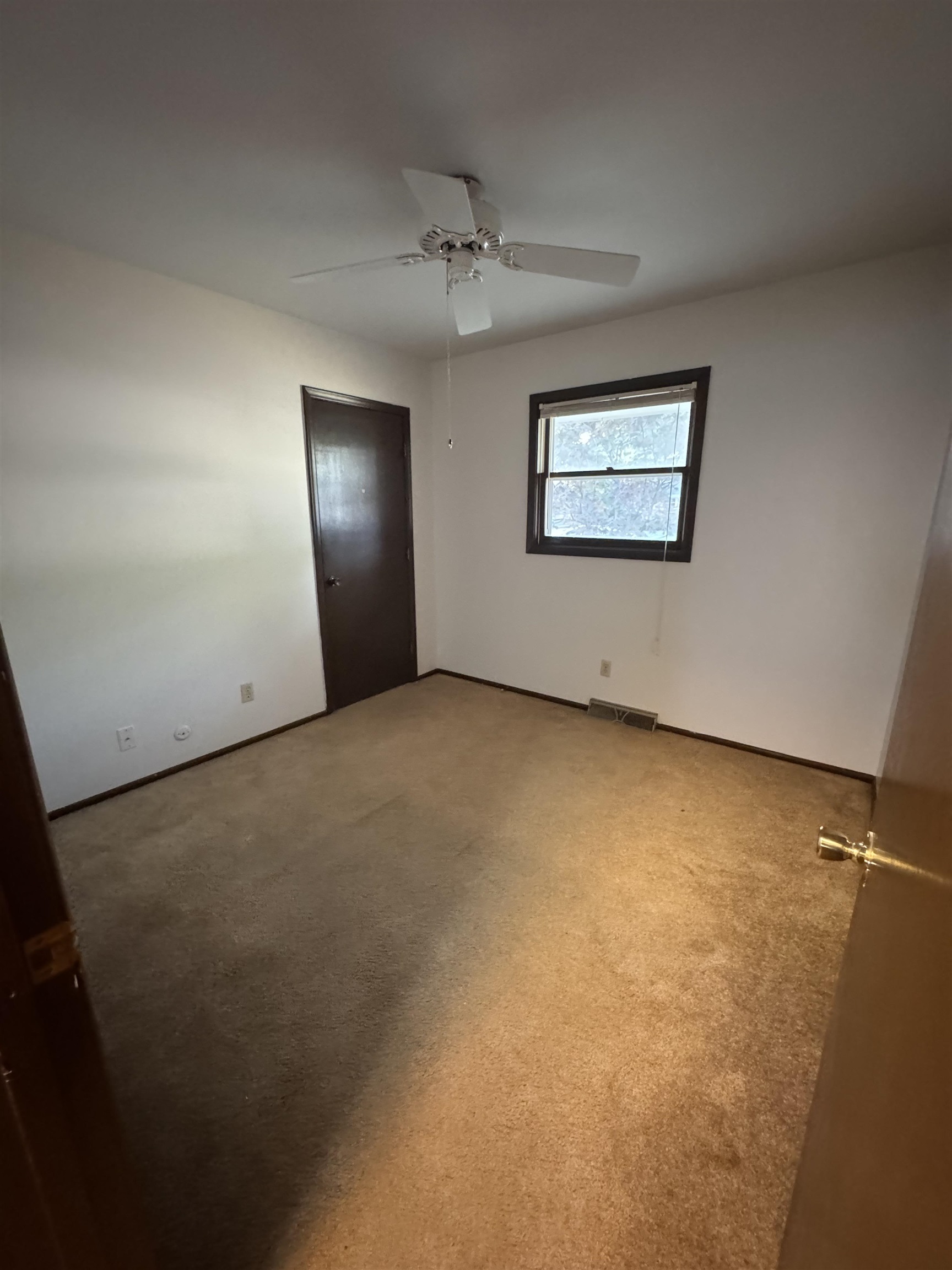 1120 Esmond Drive Rockford, IL 61108 - Photo 14 of 20 an empty room with a ceiling fan and a window