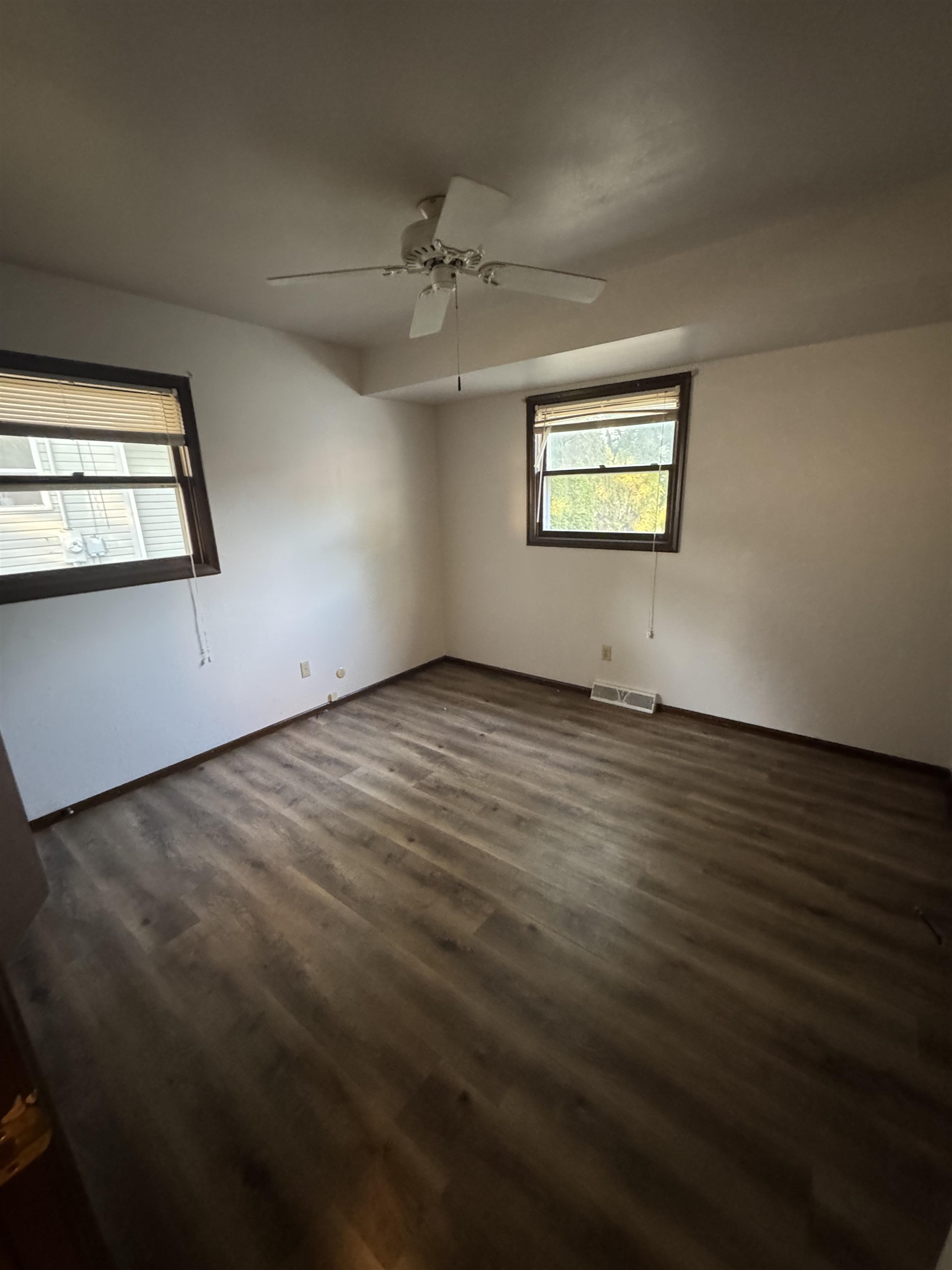 1120 Esmond Drive Rockford, IL 61108 - Photo 16 of 20 an empty room with wooden floor chandelier and windows