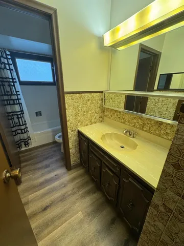 an empty room with a ceiling fan and a window