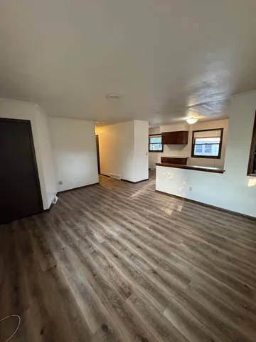 a view of a room with wooden floor