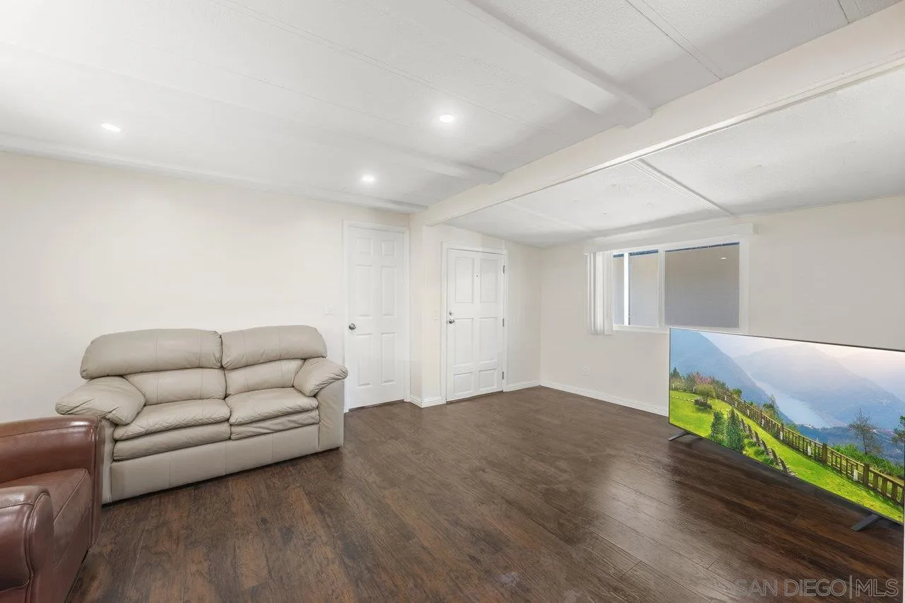 900 Howard Avenue, Unit 54 Escondido, CA 92029 - Photo 13 of 25 a living room with furniture and a wooden floor