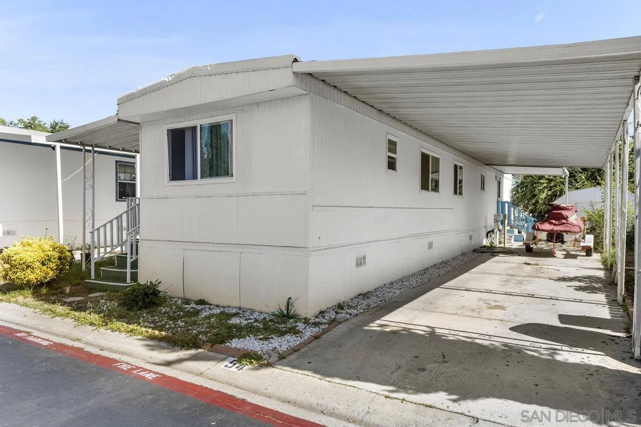 900 Howard Avenue, Unit 54 Escondido, CA 92029 - Photo 4 of 25 a view of a white house with potted plants