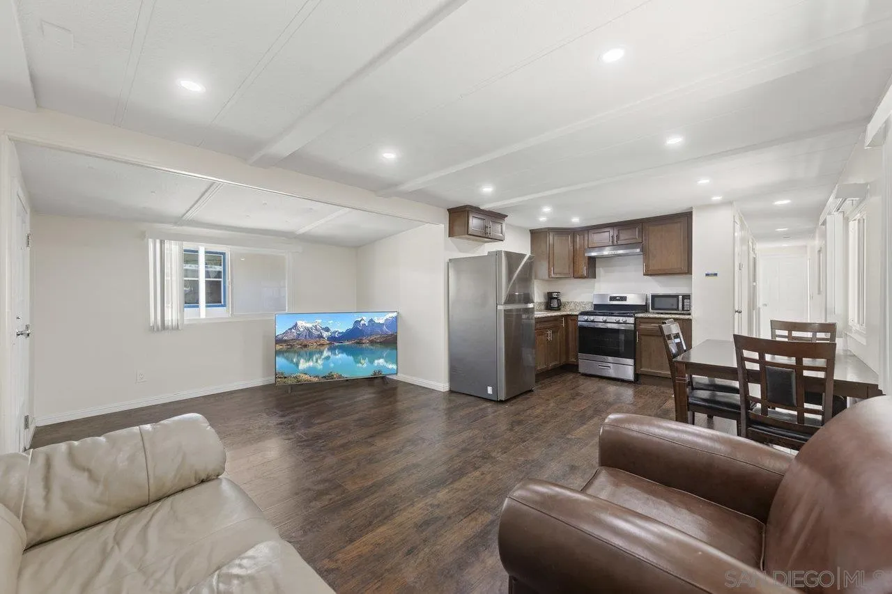 900 Howard Avenue, Unit 54 Escondido, CA 92029 - Photo 8 of 25 a living room with stainless steel appliances kitchen island a couch and a view of kitchen
