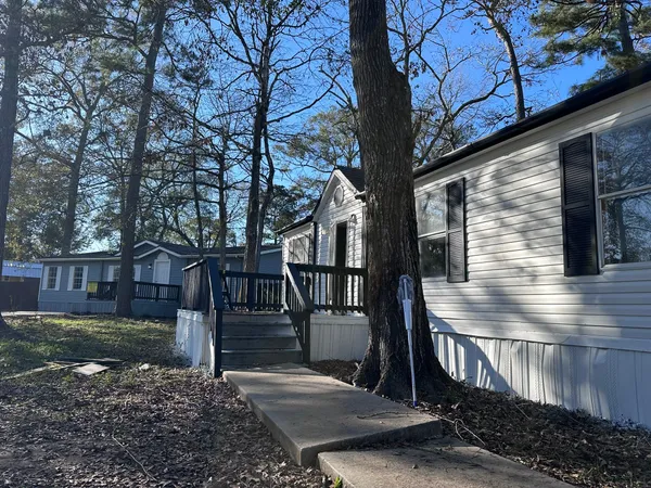 a front view of a house with yard and balcony