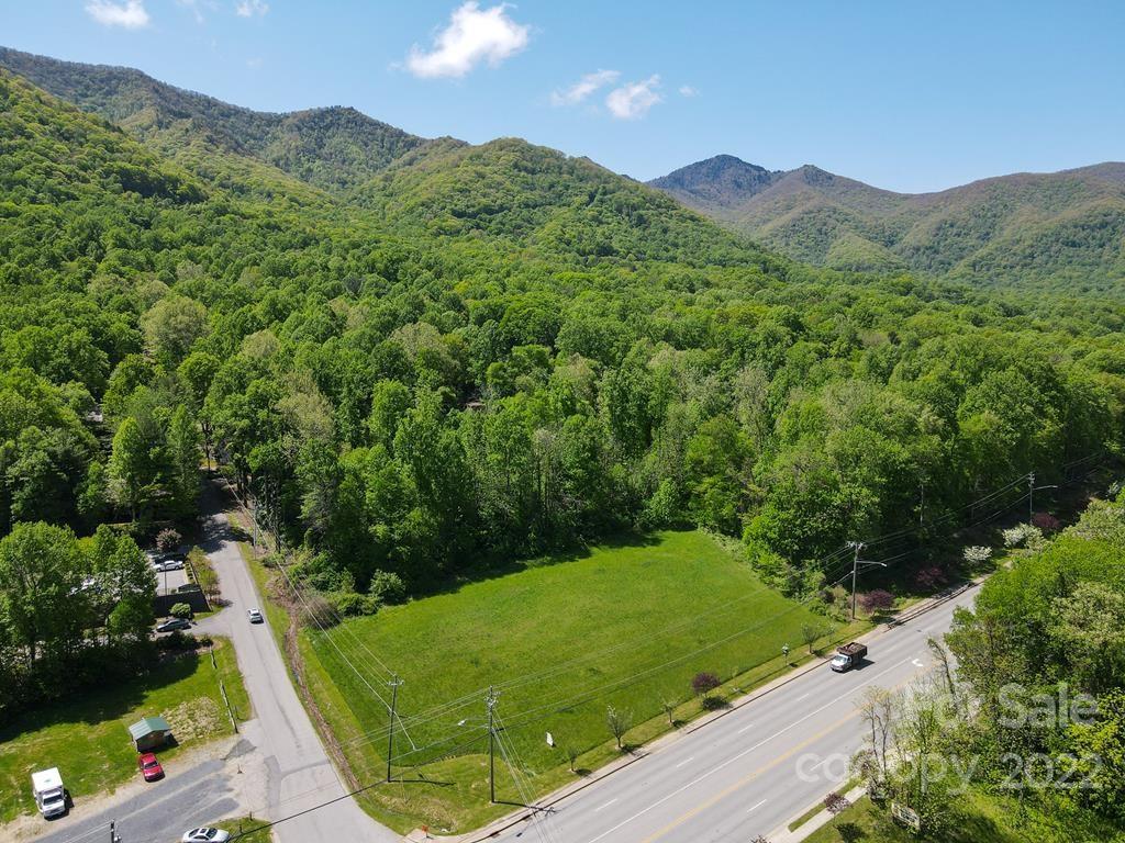 9999 A Soco Road Maggie Valley, NC 28751 - Photo 1 of 29 a view of a lush green hillside and a houses