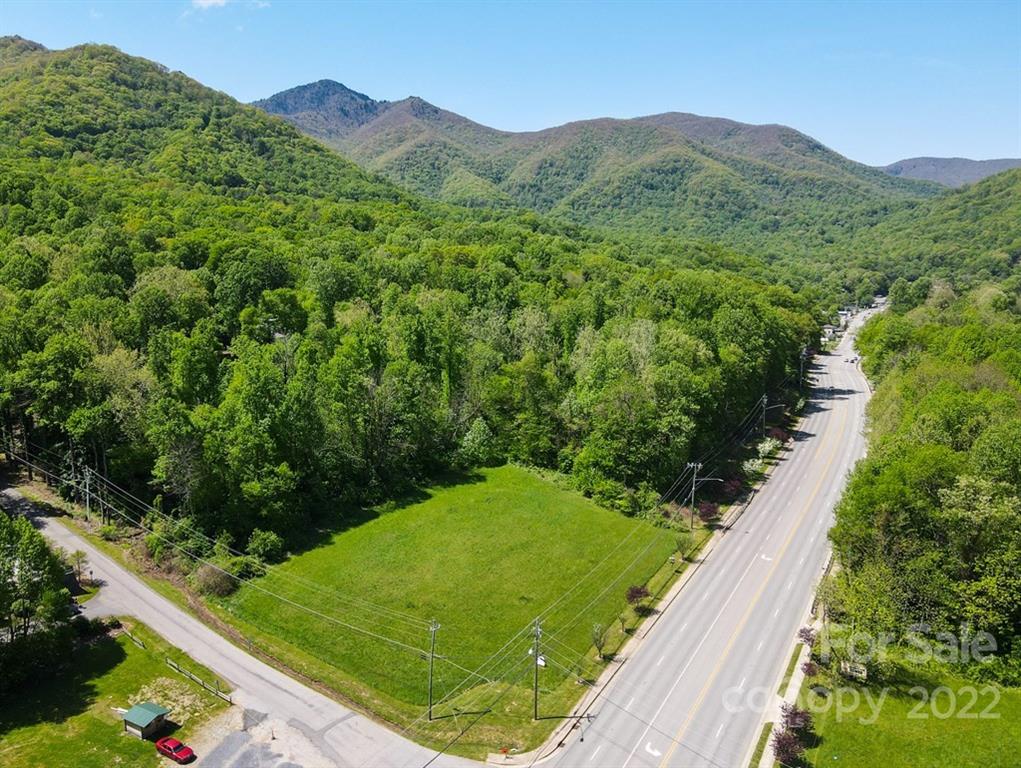9999 A Soco Road Maggie Valley, NC 28751 - Photo 2 of 29 a view of a lush green hillside and a building