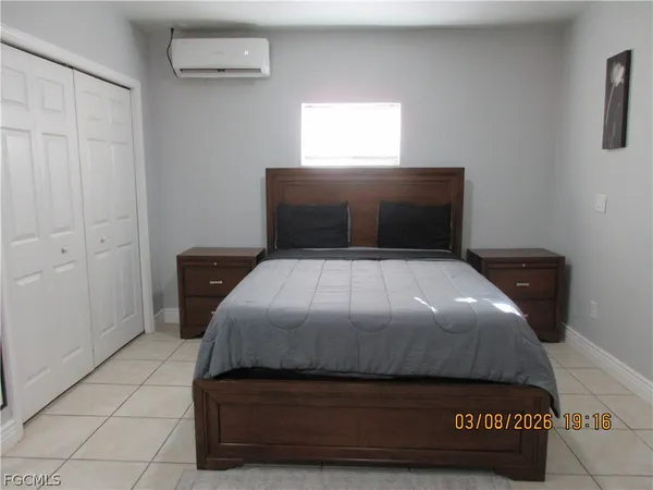 a bedroom with a bed and window