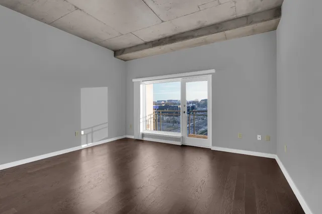 a view of wooden floor and windows in a room