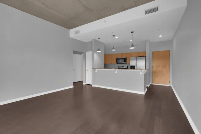 a view of a kitchen with a sink and a refrigerator