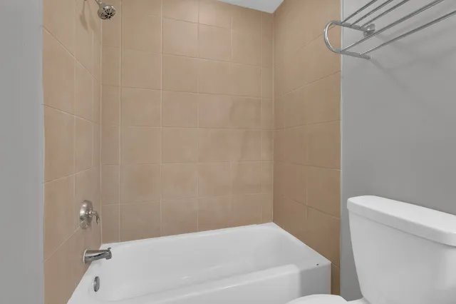 a bathroom with a bathtub and toilet