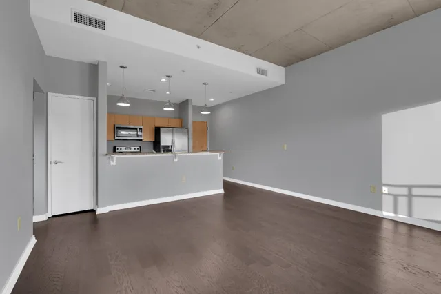 a view of a kitchen with a sink and a refrigerator