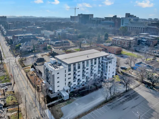 a view of a balcony with wooden benches