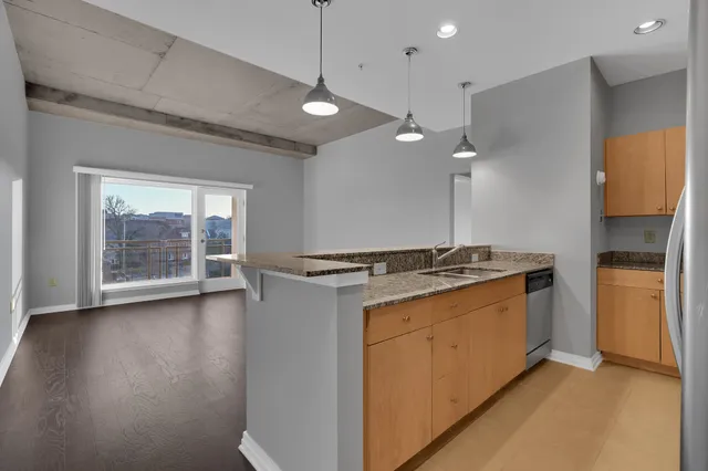 a kitchen with stainless steel appliances granite countertop a stove and a refrigerator
