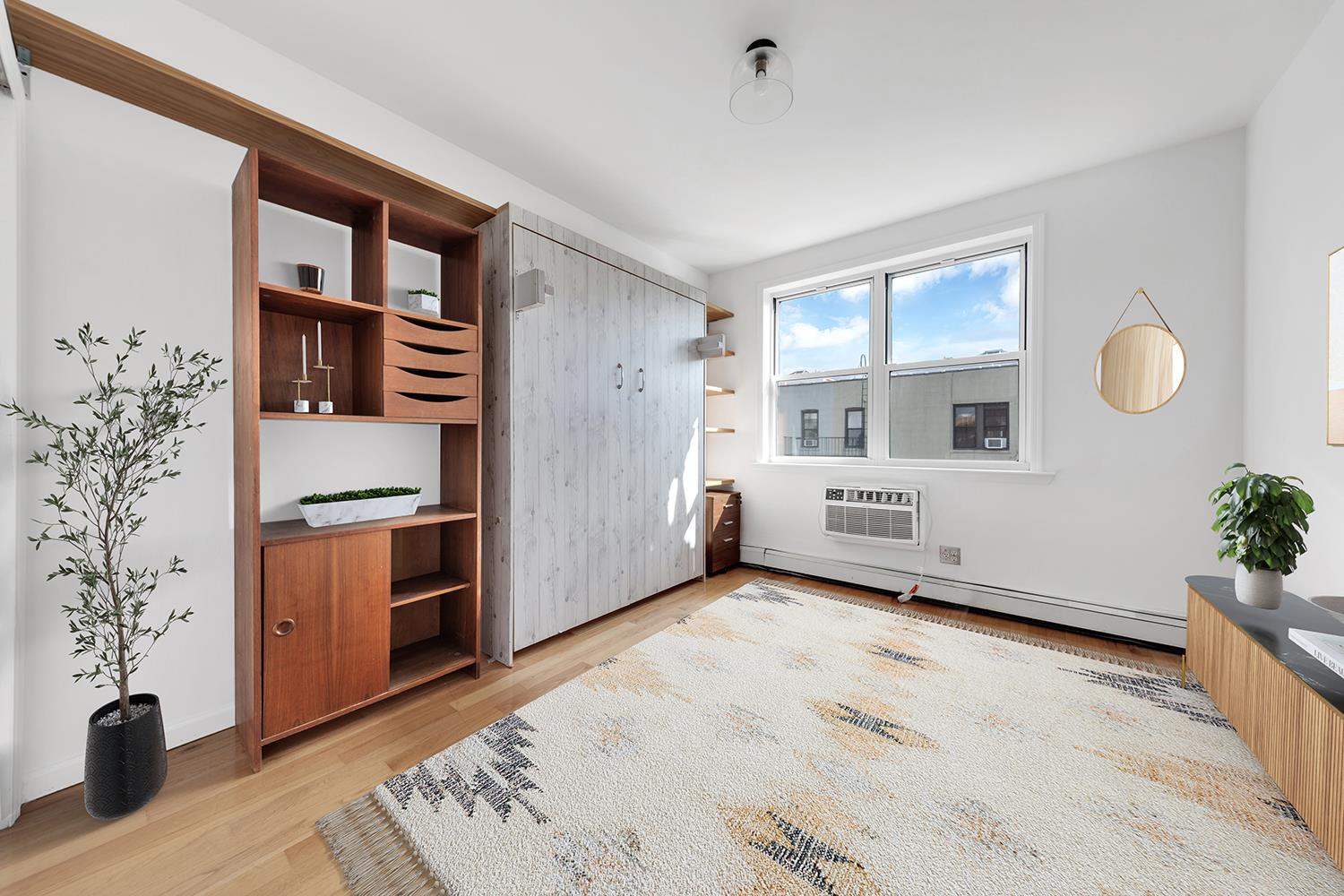 30-63 32nd Street, Unit 3B Queens, NY 11102 - Photo 4 of 12 a view of a livingroom with furniture and staircase