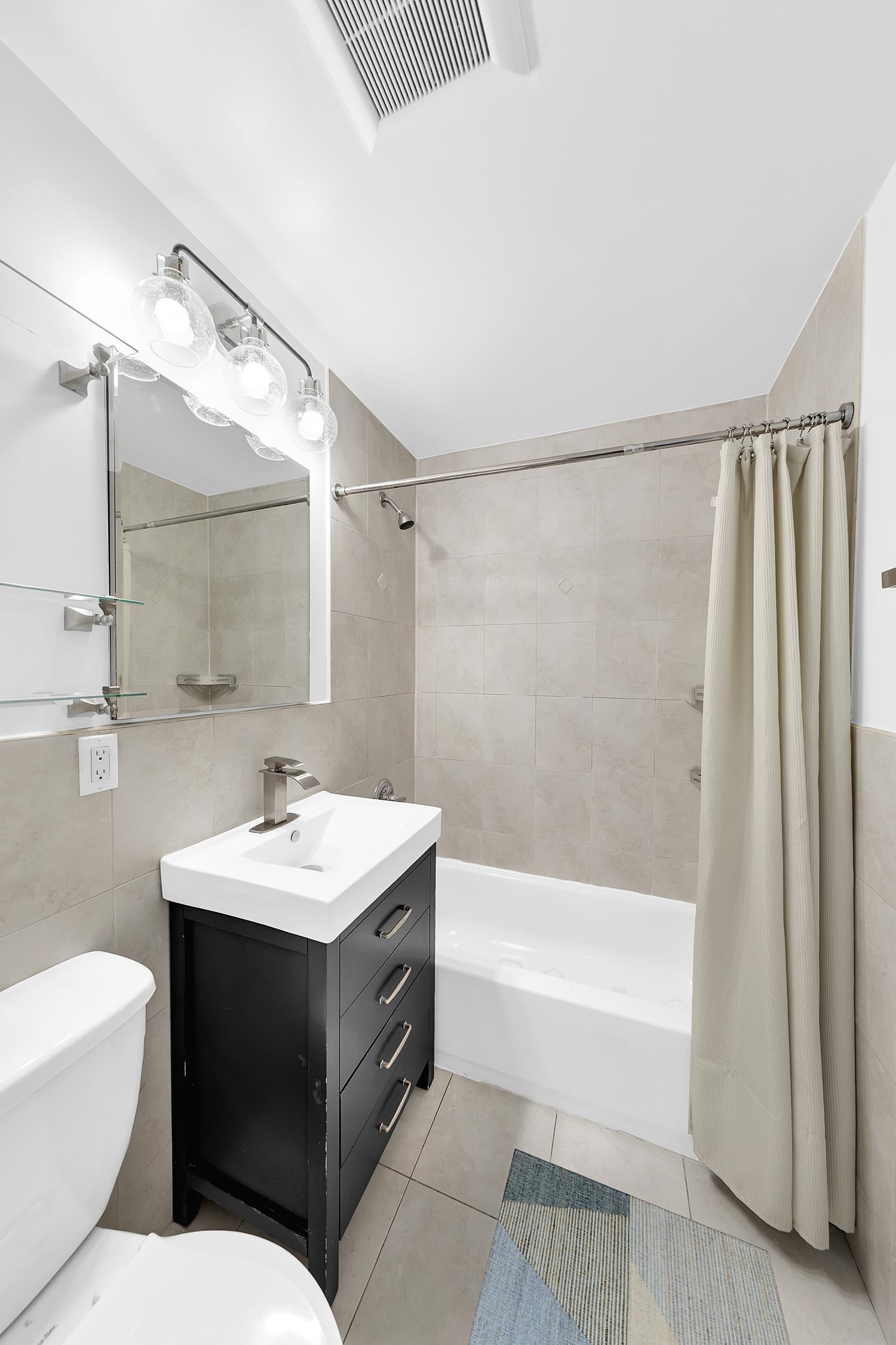 30-63 32nd Street, Unit 3B Queens, NY 11102 - Photo 6 of 12 a bathroom with a sink toilet tub and shower