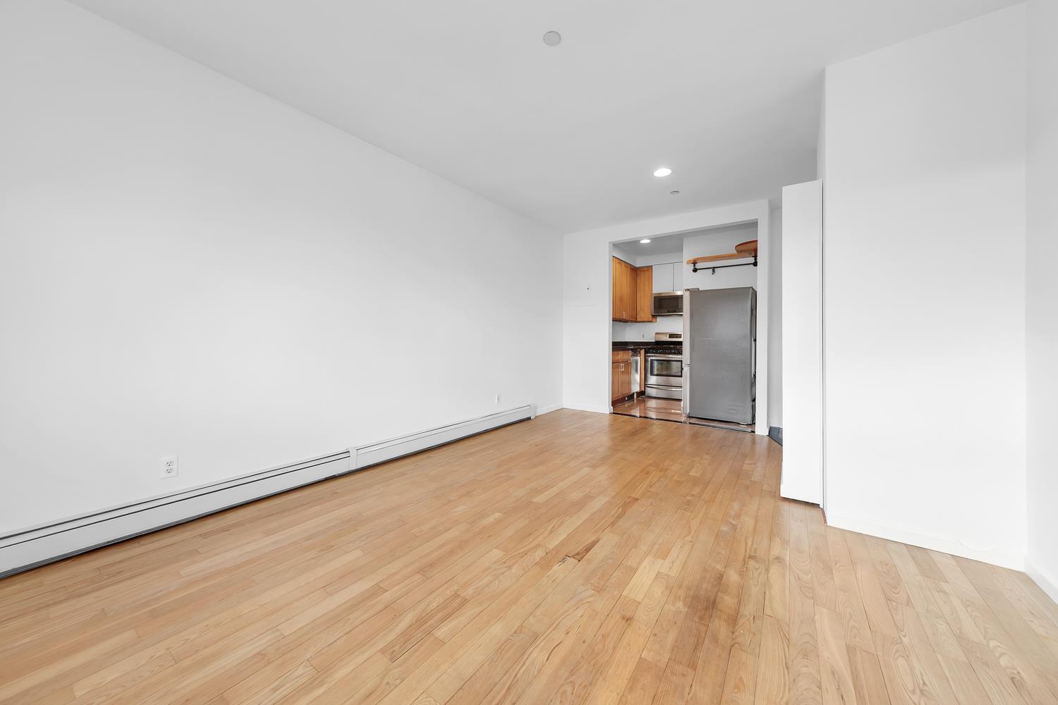 30-63 32nd Street, Unit 3B Queens, NY 11102 - Photo 7 of 12 a view of a room with wooden floor and a sink