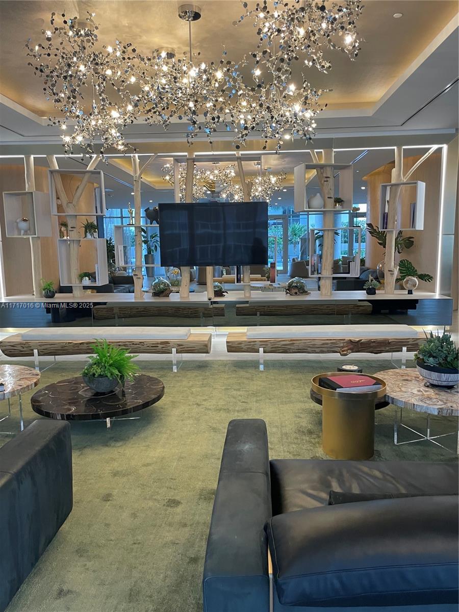 488 Northeast 18th Street, Unit 4009 Miami, FL 33132 - Photo 34 of 44 a kitchen with a table and chairs