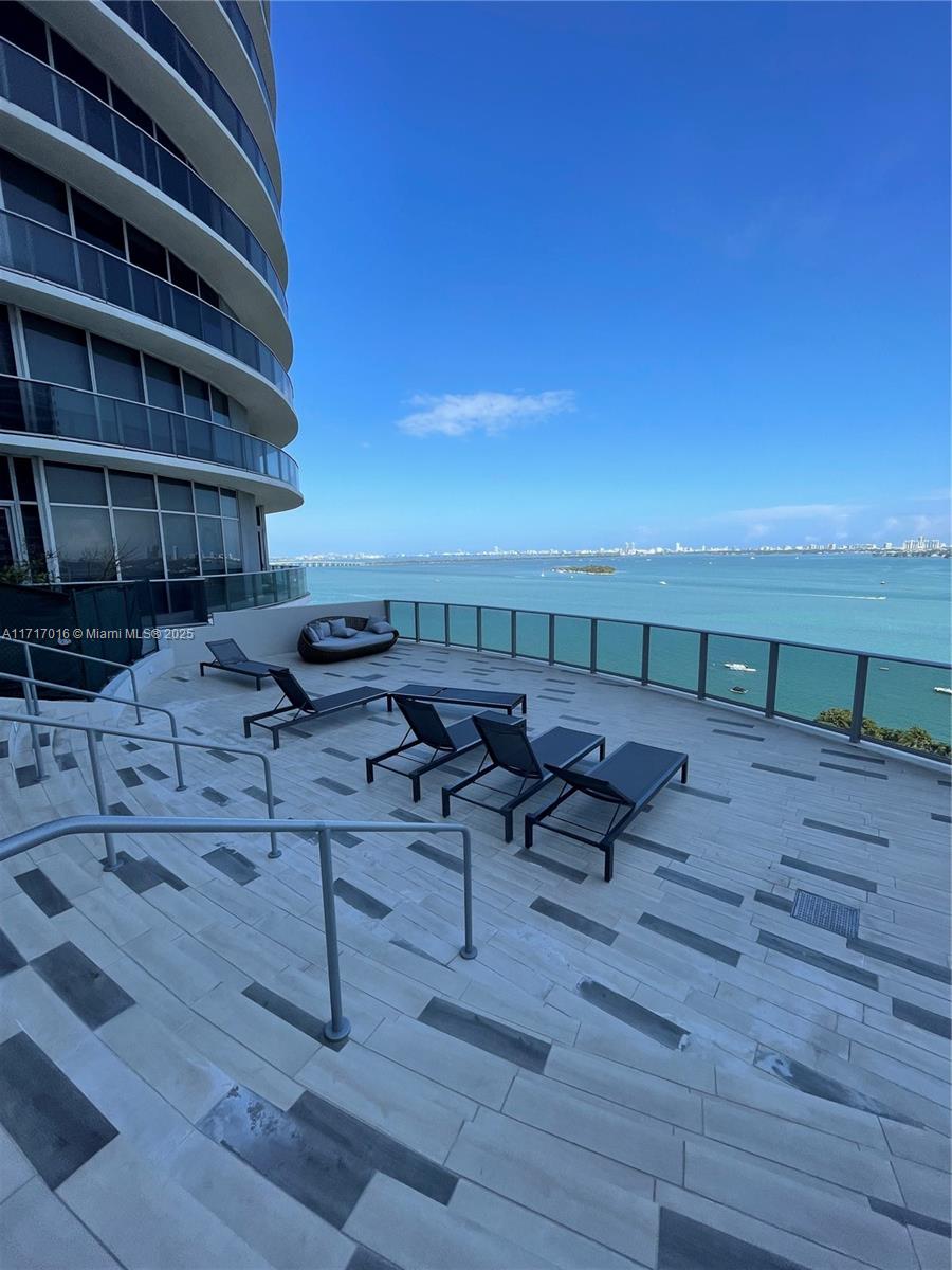 488 Northeast 18th Street, Unit 4009 Miami, FL 33132 - Photo 40 of 44 a terrace with outdoor seating and wooden floor