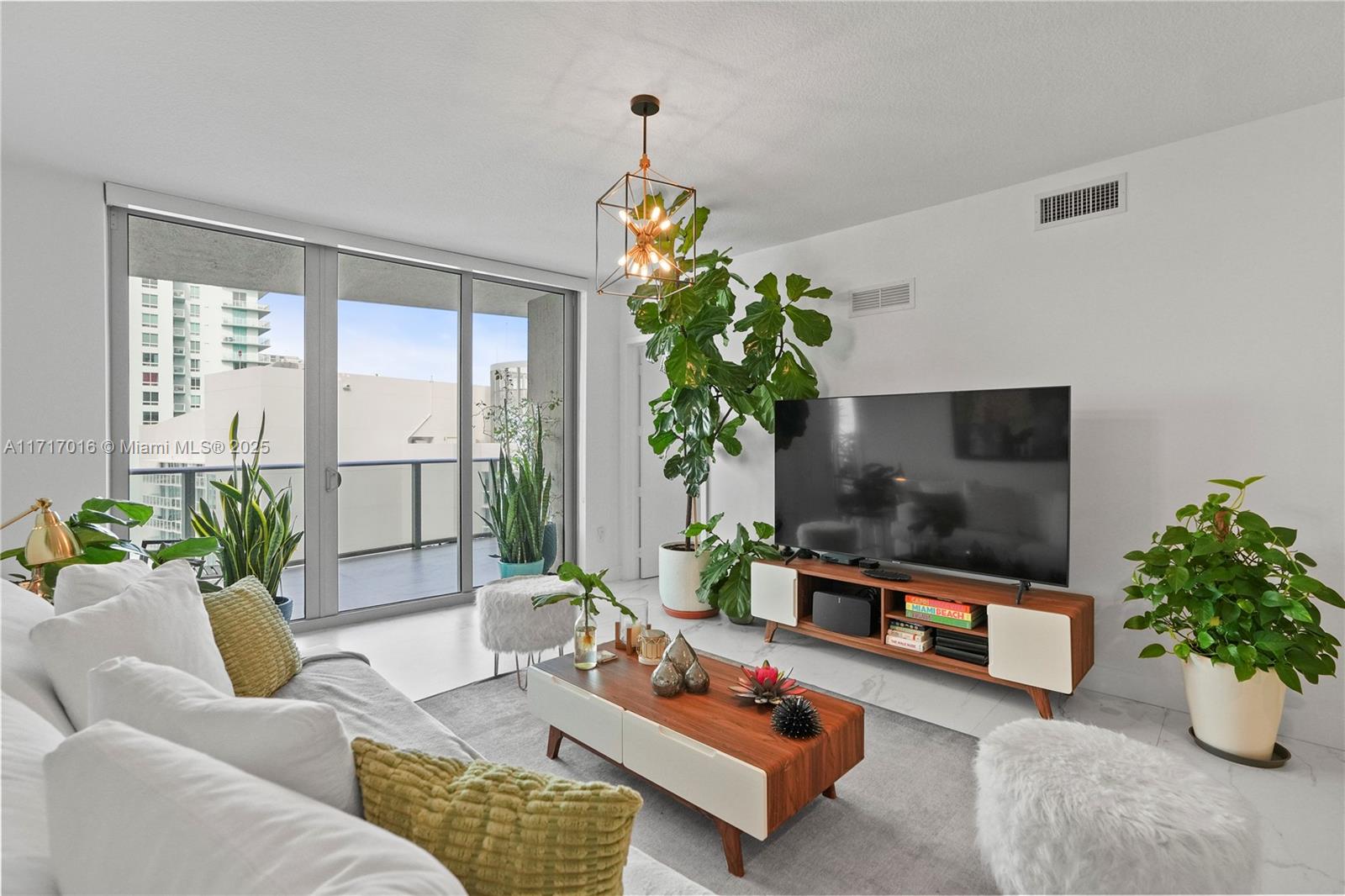 488 Northeast 18th Street, Unit 4009 Miami, FL 33132 - Photo 9 of 44 a living room with furniture and a potted plant