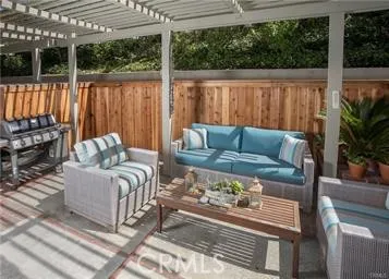 a living room with granite countertop furniture a fireplace and a flat screen tv