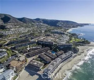 an aerial view of residential house and sandy dunes