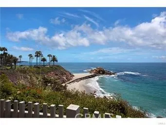a view of a swimming pool with a table and chairs under an umbrella