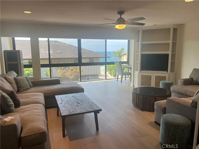 a living room with furniture and a floor to ceiling window