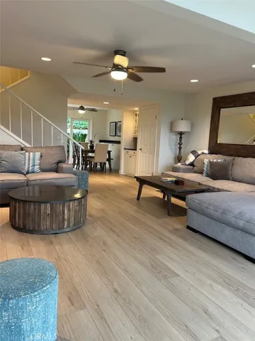 a living room with furniture and a wooden floor