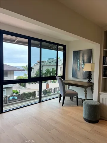 a view of a work space with furniture window and wooden floor