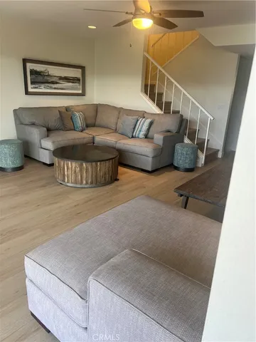 a view of a room with furniture and a large window