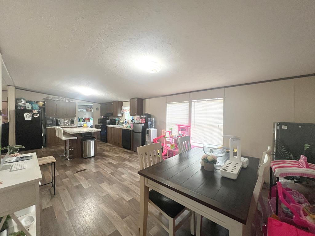 138 3rd Street Harper, TX 78631 - Photo 13 of 32 a kitchen with a table and chairs in it
