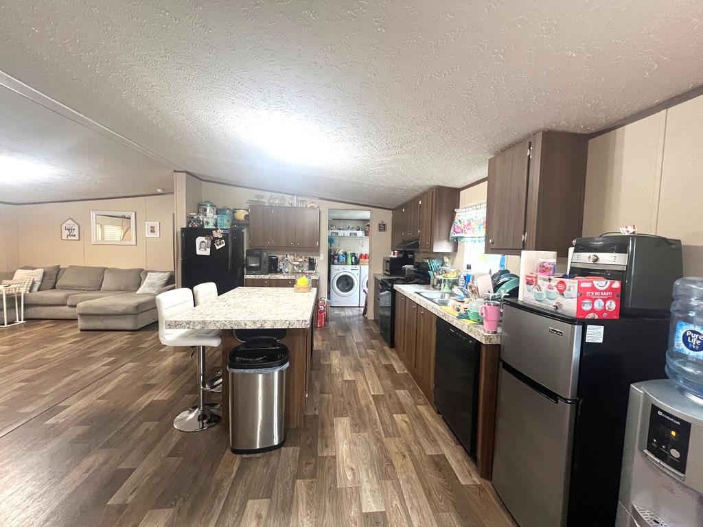 138 3rd Street Harper, TX 78631 - Photo 8 of 32 a kitchen with a sink cabinets and wooden floor