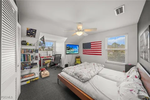 a bedroom with furniture and a large window