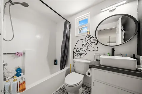 a bathroom with a toilet sink and mirror