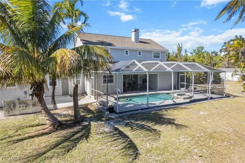 a view of a house with swimming pool and sitting area