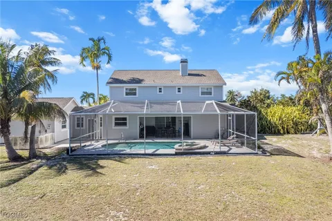 a front view of house with yard swimming pool and outdoor seating