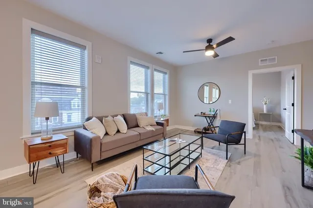 a living room with furniture and a large window