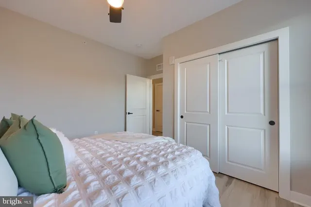 a bedroom with a bed and window with mirror