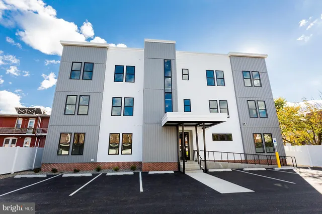 a view of living room filled with furniture and book shelf