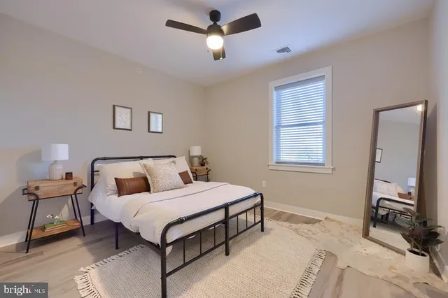 a bedroom with a bed and a window