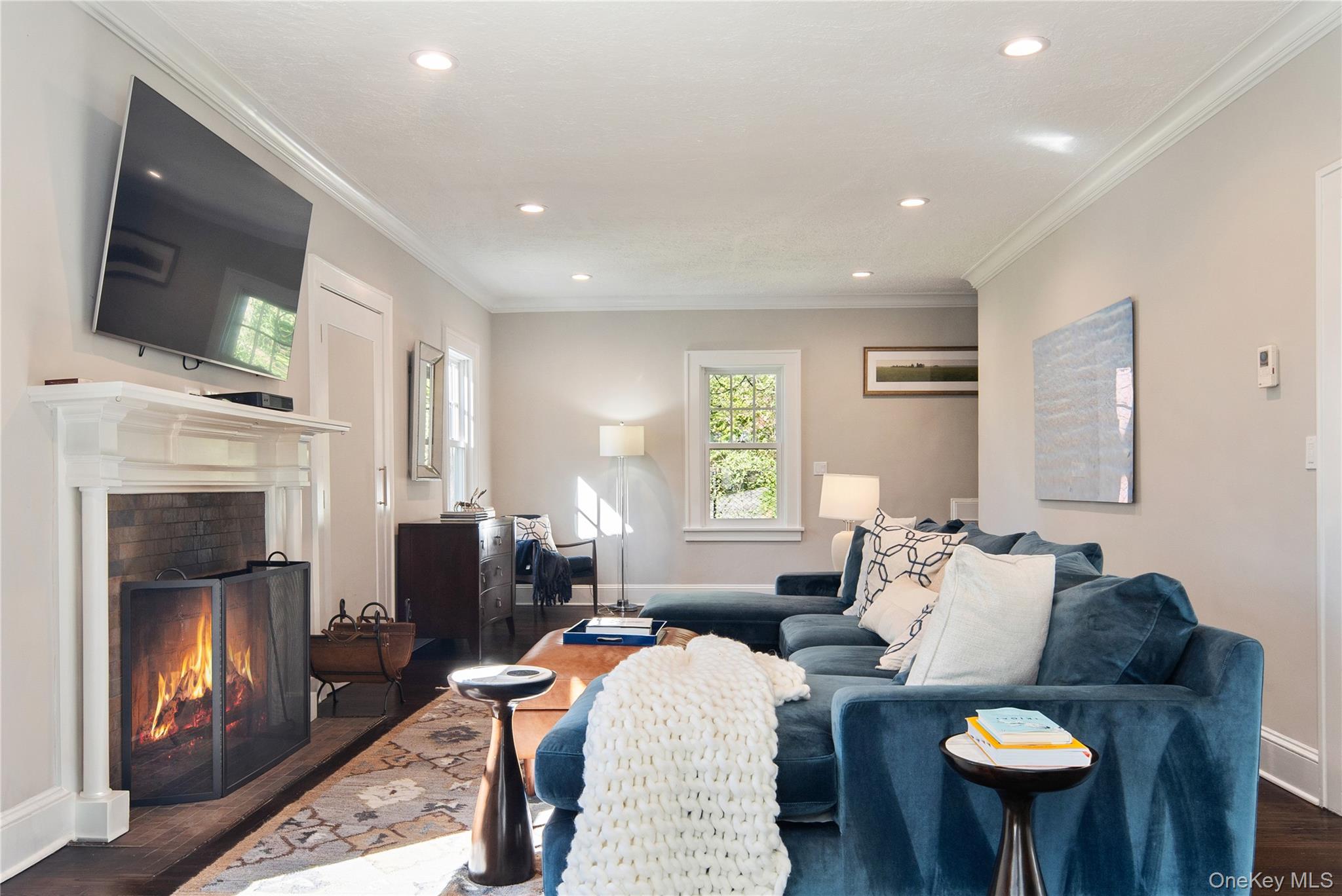 14 Aldridge Road Chappaqua, NY 10514 - Photo 10 of 38 Gracious living room with wood burning fireplace, cove style crown molding, recessed lighting-open to office/den