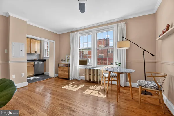 a room with furniture and a kitchen view